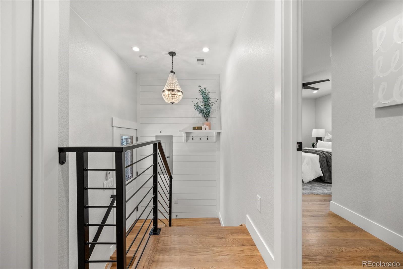 2577 Depew Street Edgewater, CO 80214 - Photo 18 of 47 a view of a hallway with wooden floor and staircase