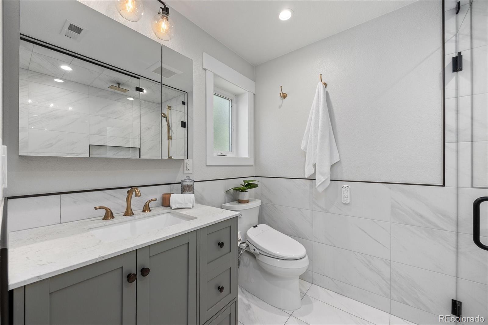 2577 Depew Street Edgewater, CO 80214 - Photo 22 of 47 a bathroom with a sink vanity granite and toilet