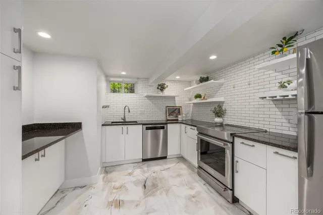 a kitchen with a sink cabinets and stainless steel appliances