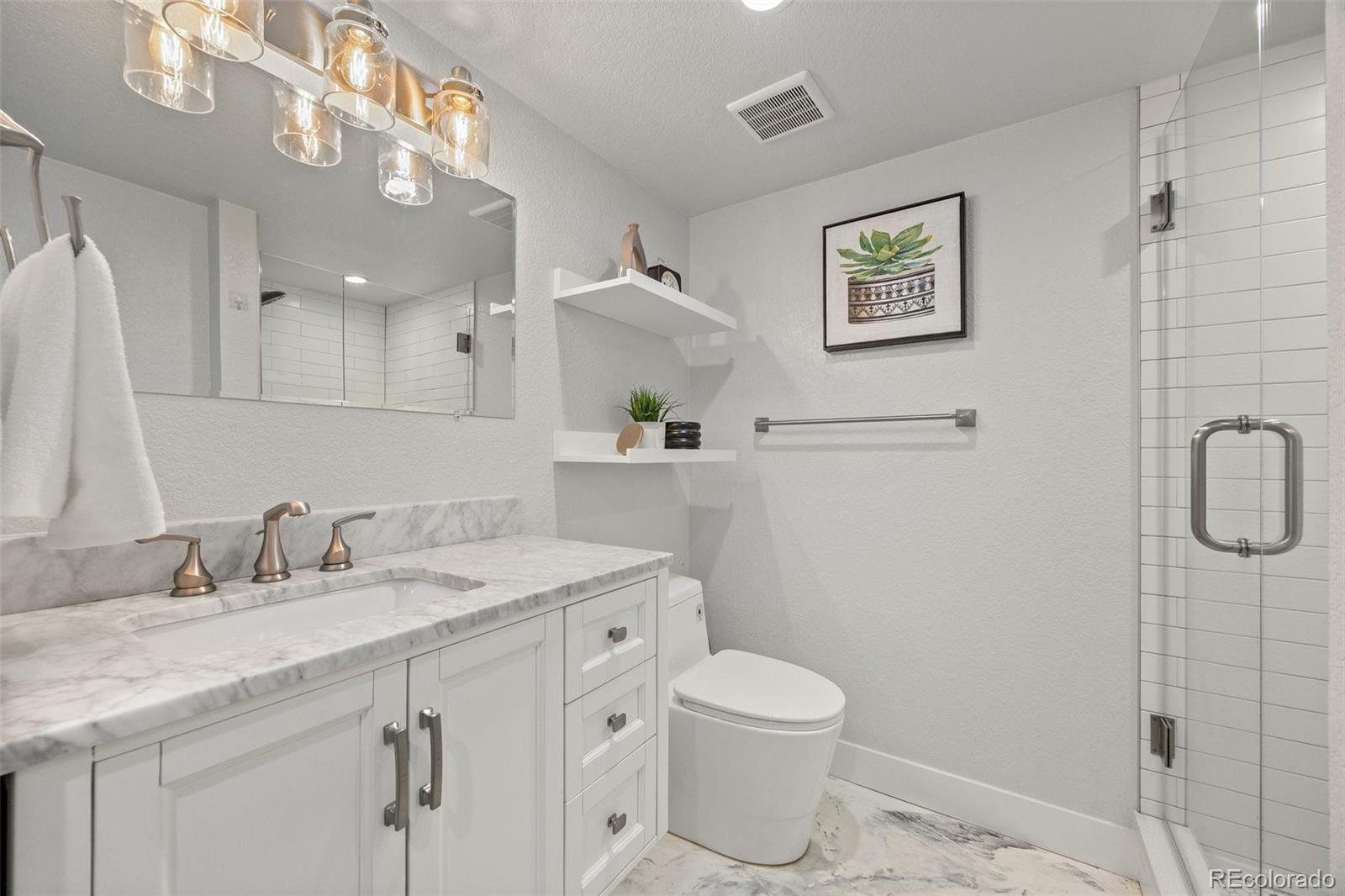2577 Depew Street Edgewater, CO 80214 - Photo 31 of 47 a bathroom with a sink toilet and shower