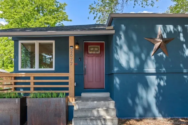 a front view of a house with a garden