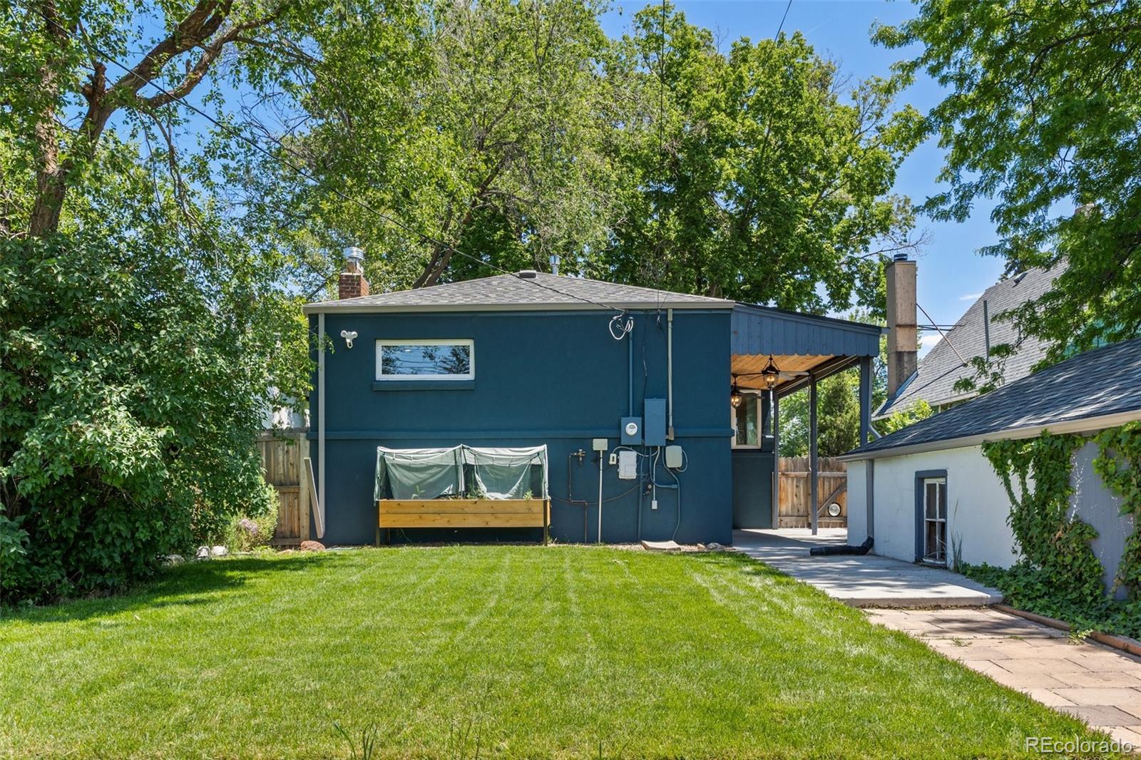 2577 Depew Street Edgewater, CO 80214 - Photo 40 of 47 a front view of a house with a yard and garage