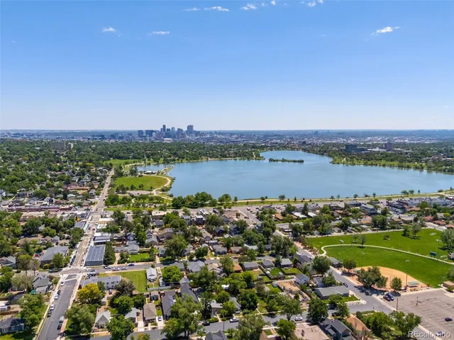 an aerial view of a residential houses with outdoor space and river