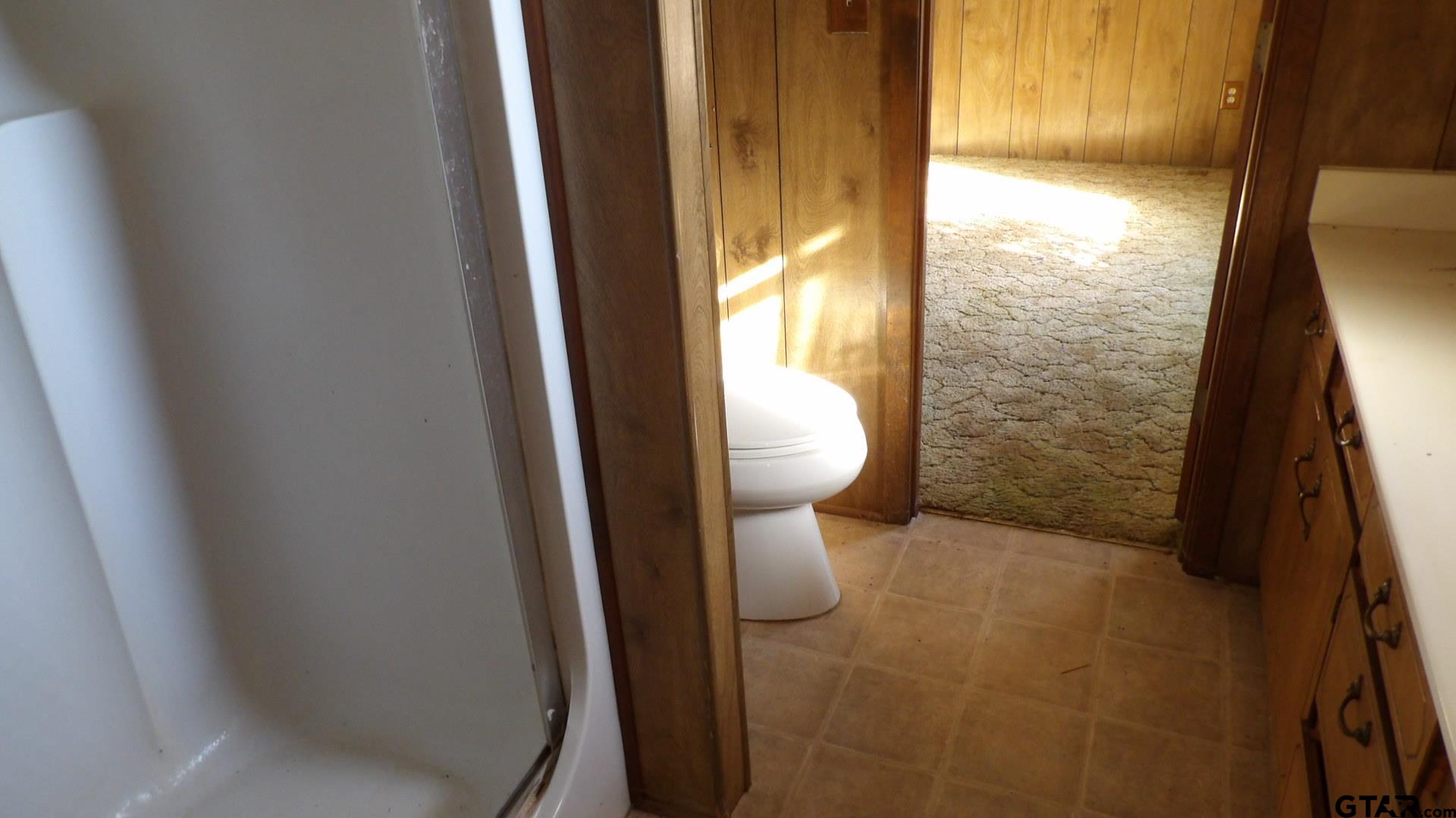 705 Wiley Boulevard Big Sandy, TX 75755 - Photo 13 of 17 a bathroom with a toilet and a shower