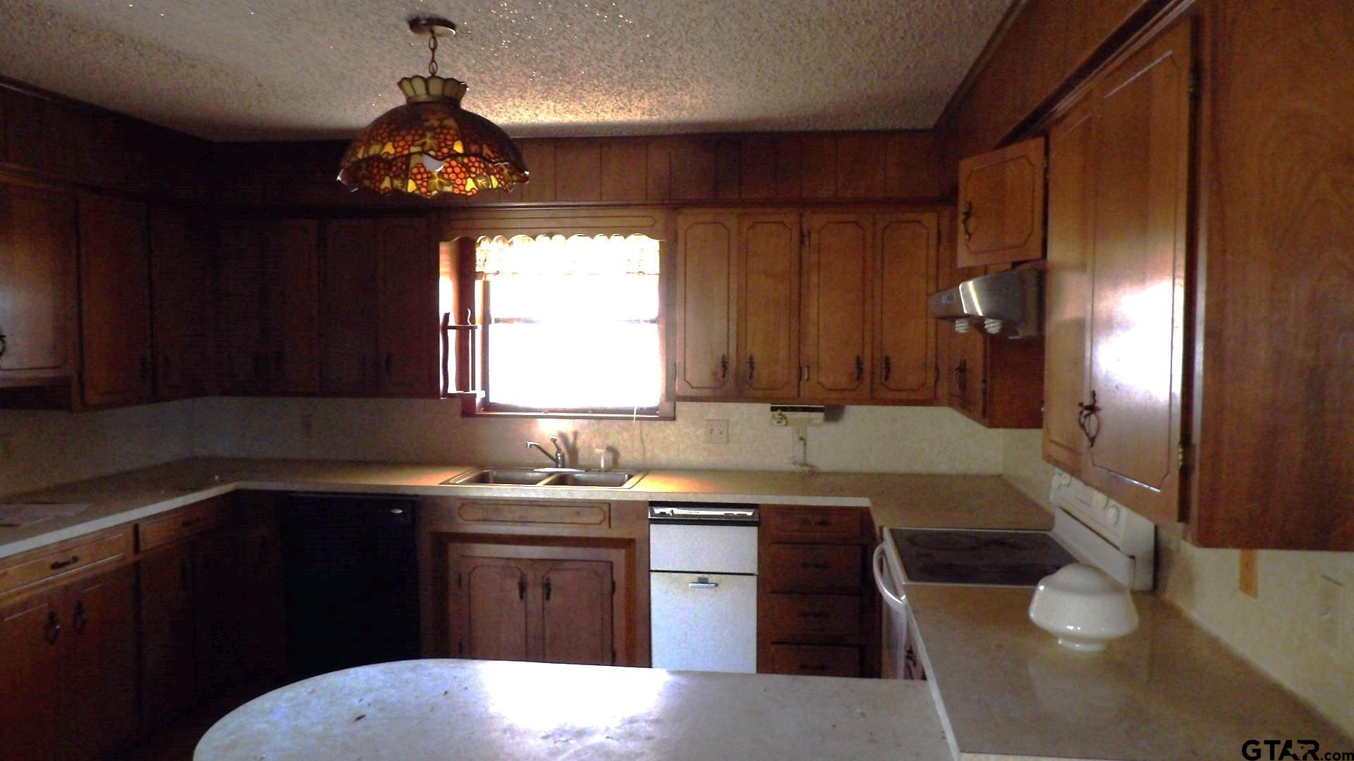 705 Wiley Boulevard Big Sandy, TX 75755 - Photo 5 of 17 a kitchen with a sink stove and cabinets