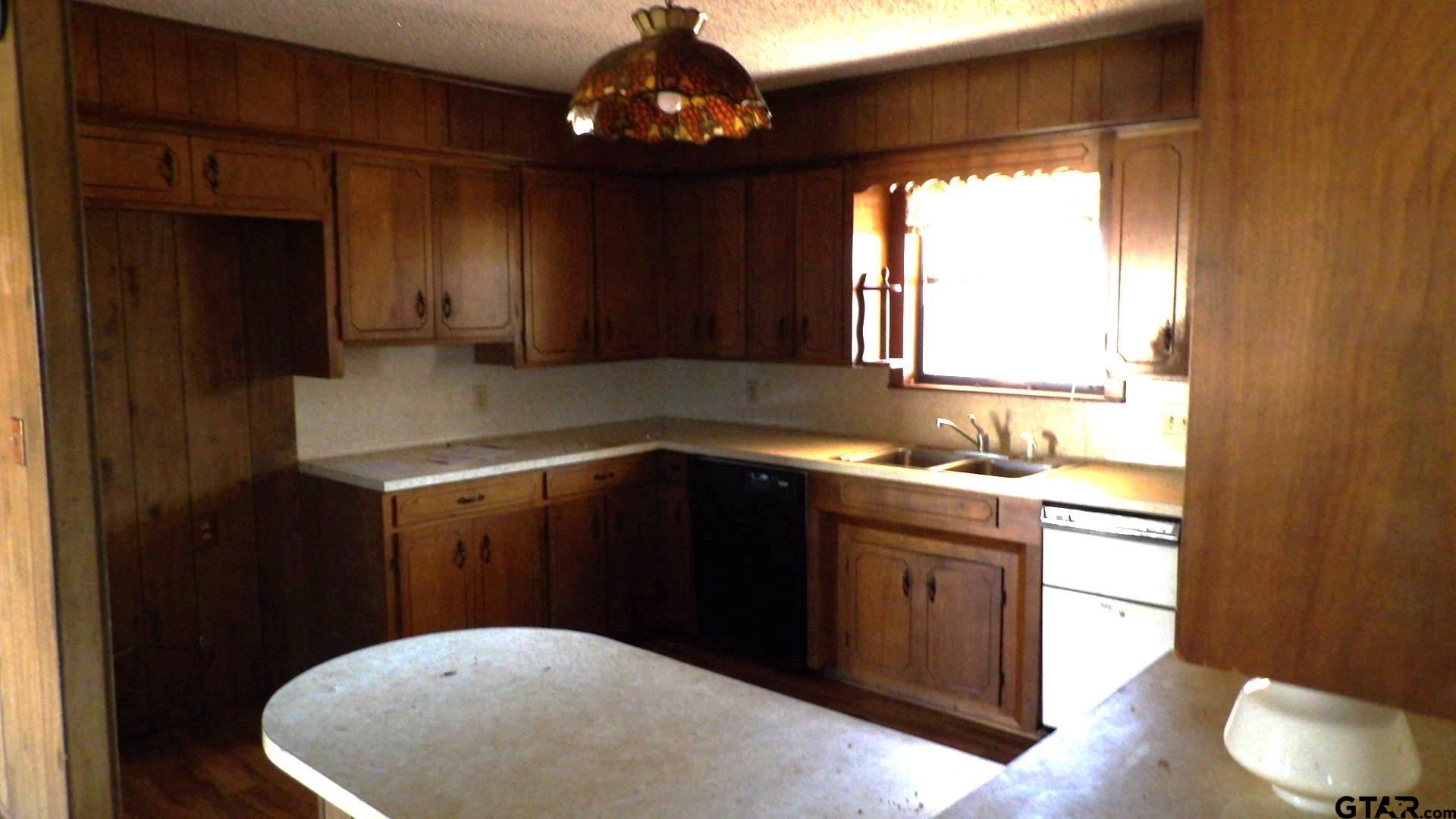 705 Wiley Boulevard Big Sandy, TX 75755 - Photo 6 of 17 a kitchen with a sink cabinets and window