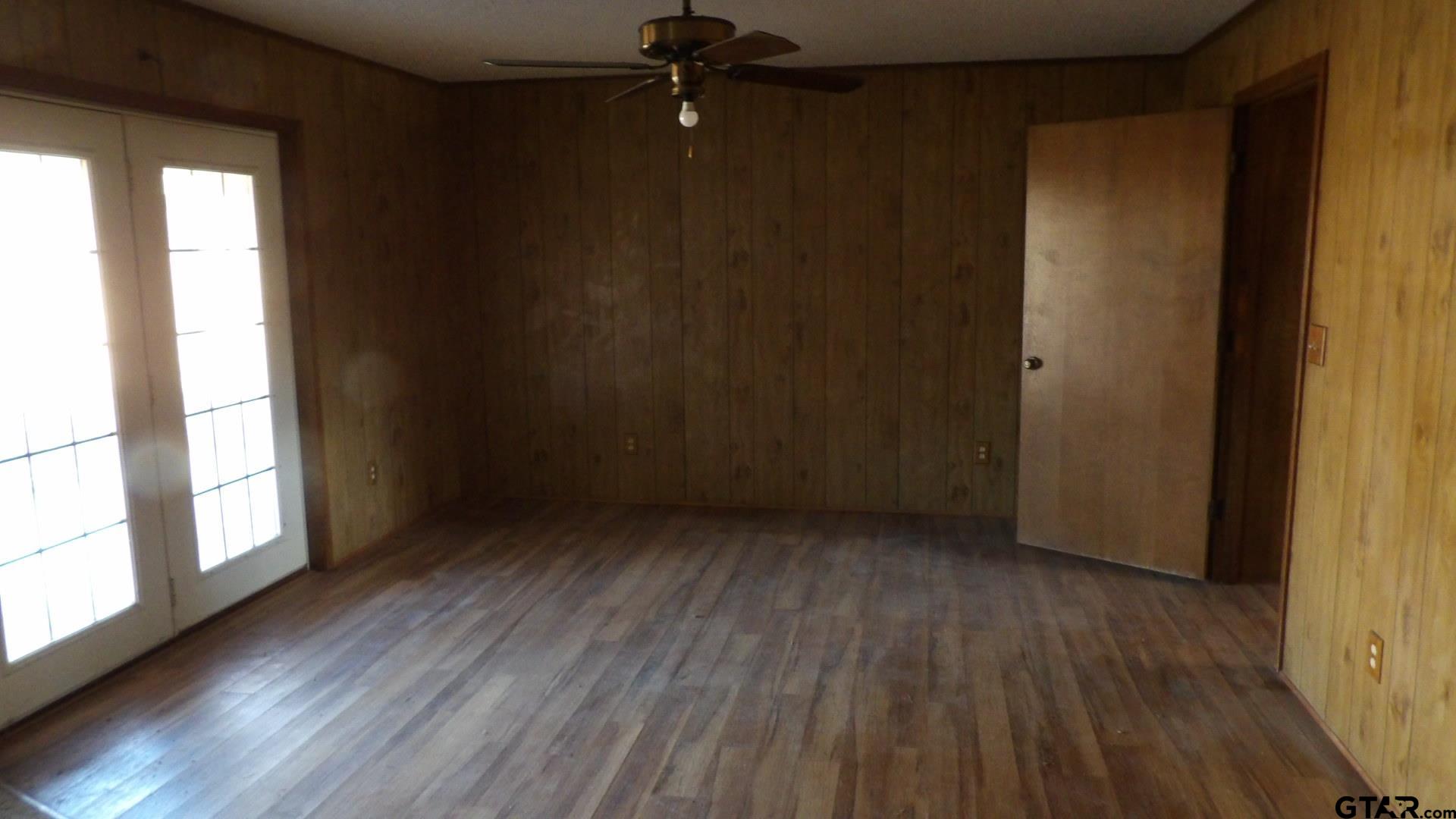 705 Wiley Boulevard Big Sandy, TX 75755 - Photo 7 of 17 a view of an empty room with wooden floor and a window