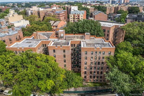 an aerial view of a building with garden space and street view