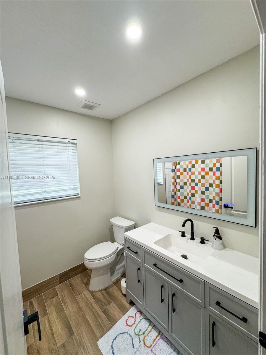 27841 Southwest 140th Avenue Homestead, FL 33032 - Photo 17 of 28 a bathroom with a sink and a toilet