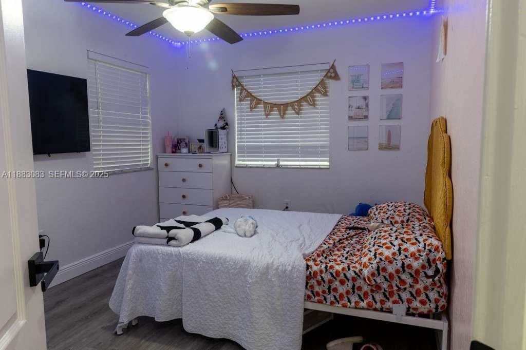 27841 Southwest 140th Avenue Homestead, FL 33032 - Photo 19 of 28 a bedroom with a bed and a flat screen tv