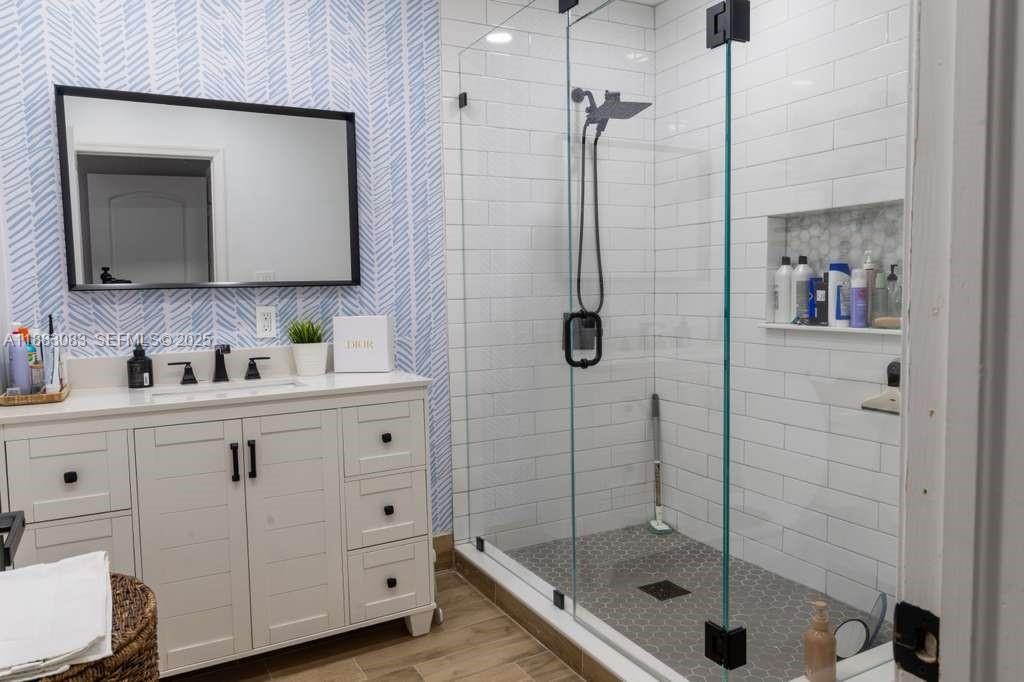 27841 Southwest 140th Avenue Homestead, FL 33032 - Photo 21 of 28 a bathroom with a shower sink and mirror