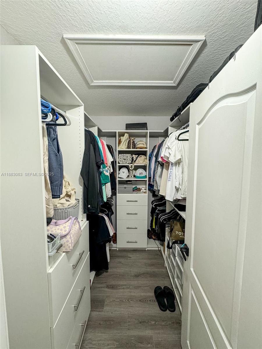 27841 Southwest 140th Avenue Homestead, FL 33032 - Photo 22 of 28 a view of walk in closet with clothes and shoes