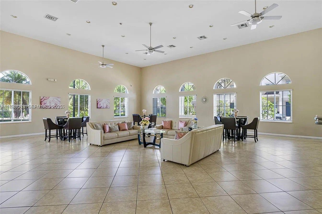 27841 Southwest 140th Avenue Homestead, FL 33032 - Photo 24 of 28 a living room with patio furniture and a chandelier