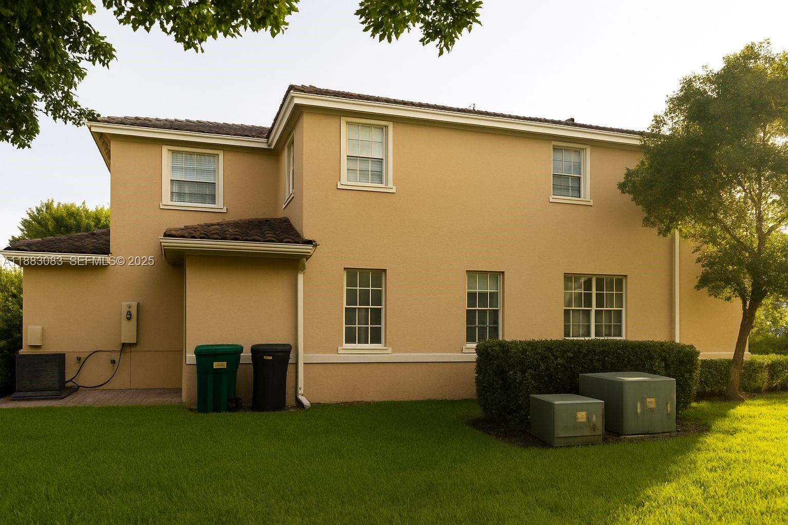 27841 Southwest 140th Avenue Homestead, FL 33032 - Photo 3 of 28 a front view of a house with many windows
