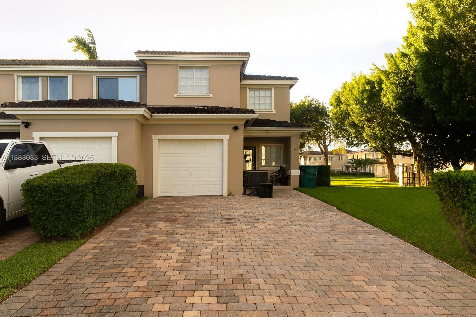 27841 Southwest 140th Avenue Homestead, FL 33032 - Photo 4 of 28 a front view of a house with a yard and garage