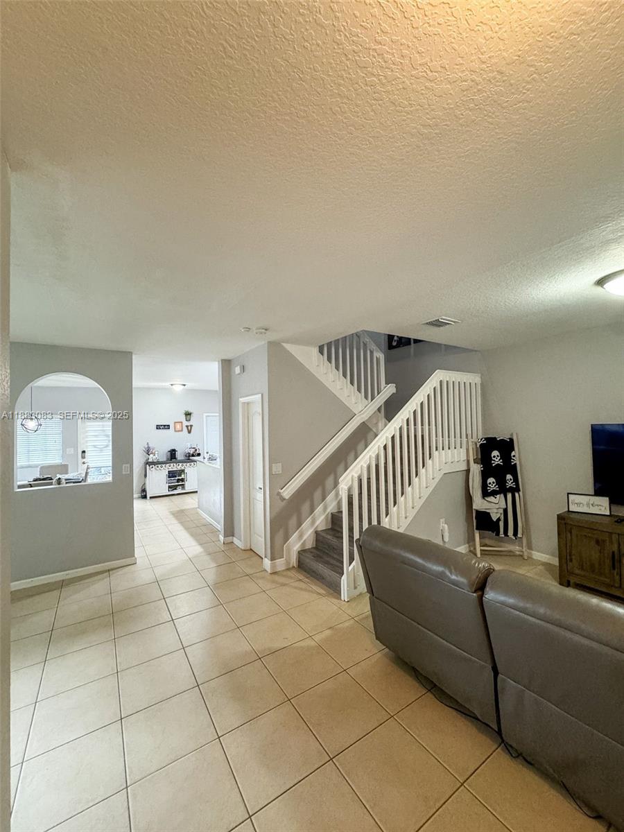 27841 Southwest 140th Avenue Homestead, FL 33032 - Photo 7 of 28 a living room with furniture and stairs