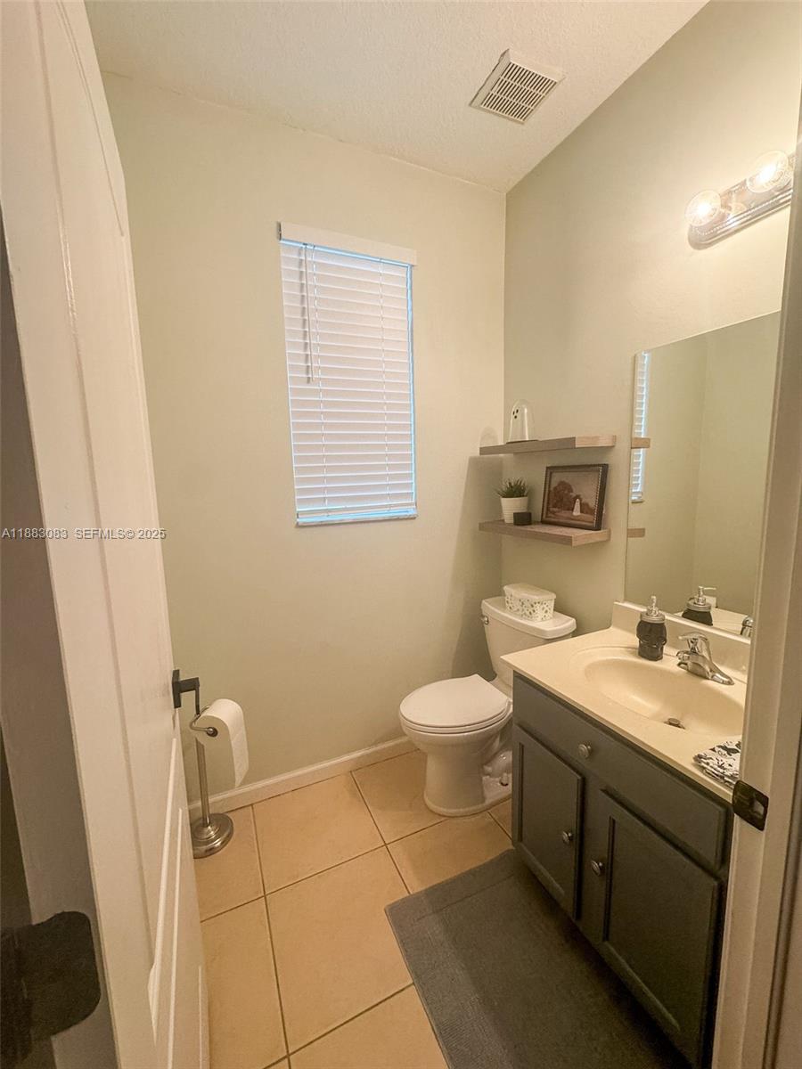 27841 Southwest 140th Avenue Homestead, FL 33032 - Photo 8 of 28 a bathroom with a granite countertop sink toilet and mirror