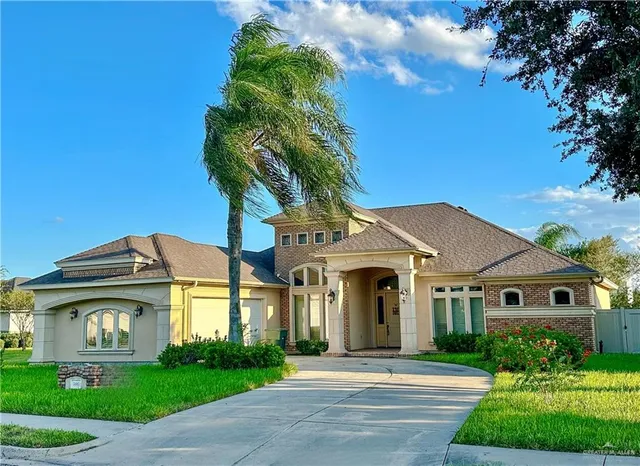 a front view of a house with a garden and plants