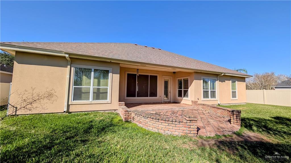 5805 Acacia Harlingen, TX 78552 - Photo 22 of 23 Back of property with a patio area, stucco siding, and a shingled roof