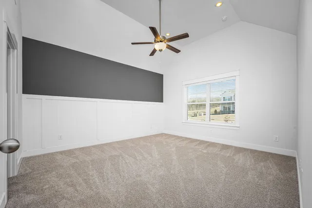 a view of an empty room with a fireplace and a window