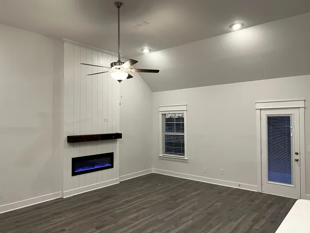 a bathroom with a granite countertop sink a toilet and a mirror