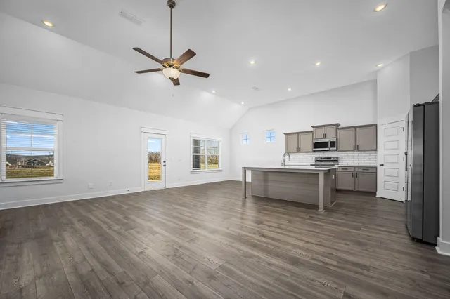 a view of kitchen with sink and refrigerator
