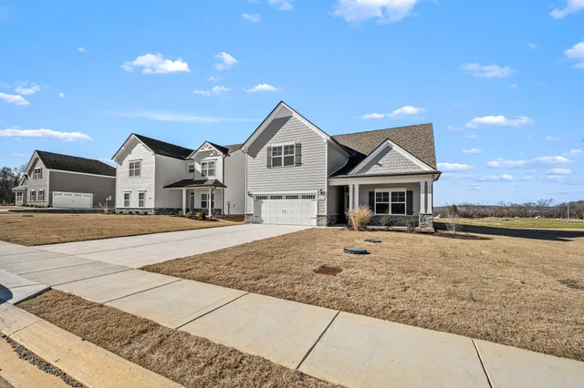 a front view of a house with yard and ocean view