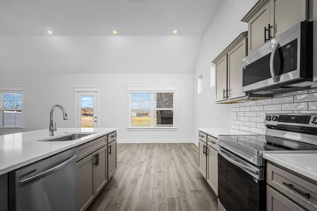 a view of a kitchen with microwave and stove top oven