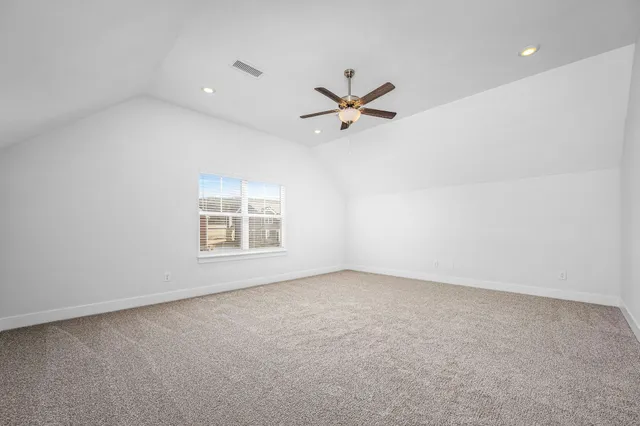 a view of room with a ceiling fan and window