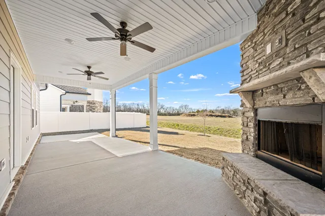 a front view of a house with a yard and ocean view