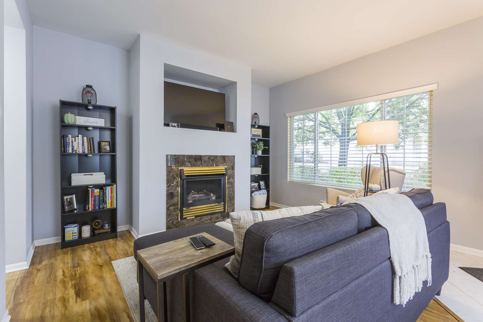 147 Heather Glen Drive, Unit 147 Aurora, IL 60504 - Photo 2 of 14 a bedroom with a bed a fireplace and a large window