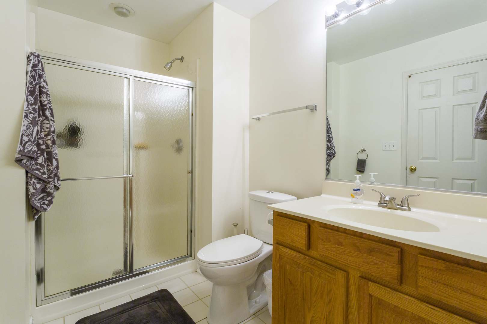147 Heather Glen Drive, Unit 147 Aurora, IL 60504 - Photo 12 of 14 a bathroom with a sink toilet and shower