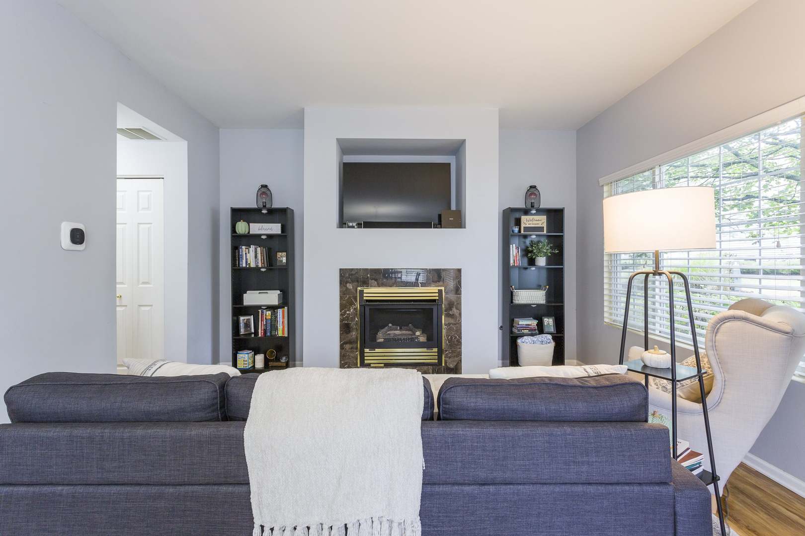 147 Heather Glen Drive, Unit 147 Aurora, IL 60504 - Photo 3 of 14 a living room with furniture a flat screen tv and a fireplace