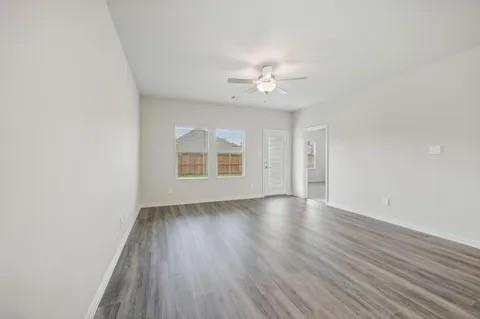 519 Ridgedale Drive McKinney, TX 75071 - Photo 14 of 26 an empty room with wooden floor and windows