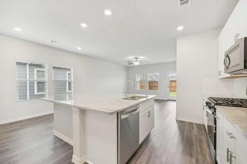 519 Ridgedale Drive McKinney, TX 75071 - Photo 5 of 26 a kitchen with a sink stove and wooden floor