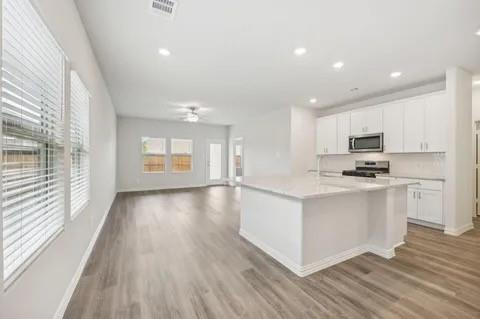519 Ridgedale Drive McKinney, TX 75071 - Photo 7 of 26 a view of kitchen with wooden floor and electronic appliances