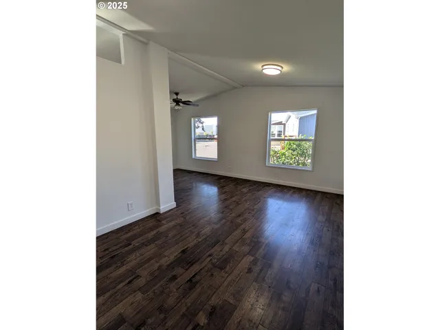 a kitchen with granite countertop a stove and a wooden floors