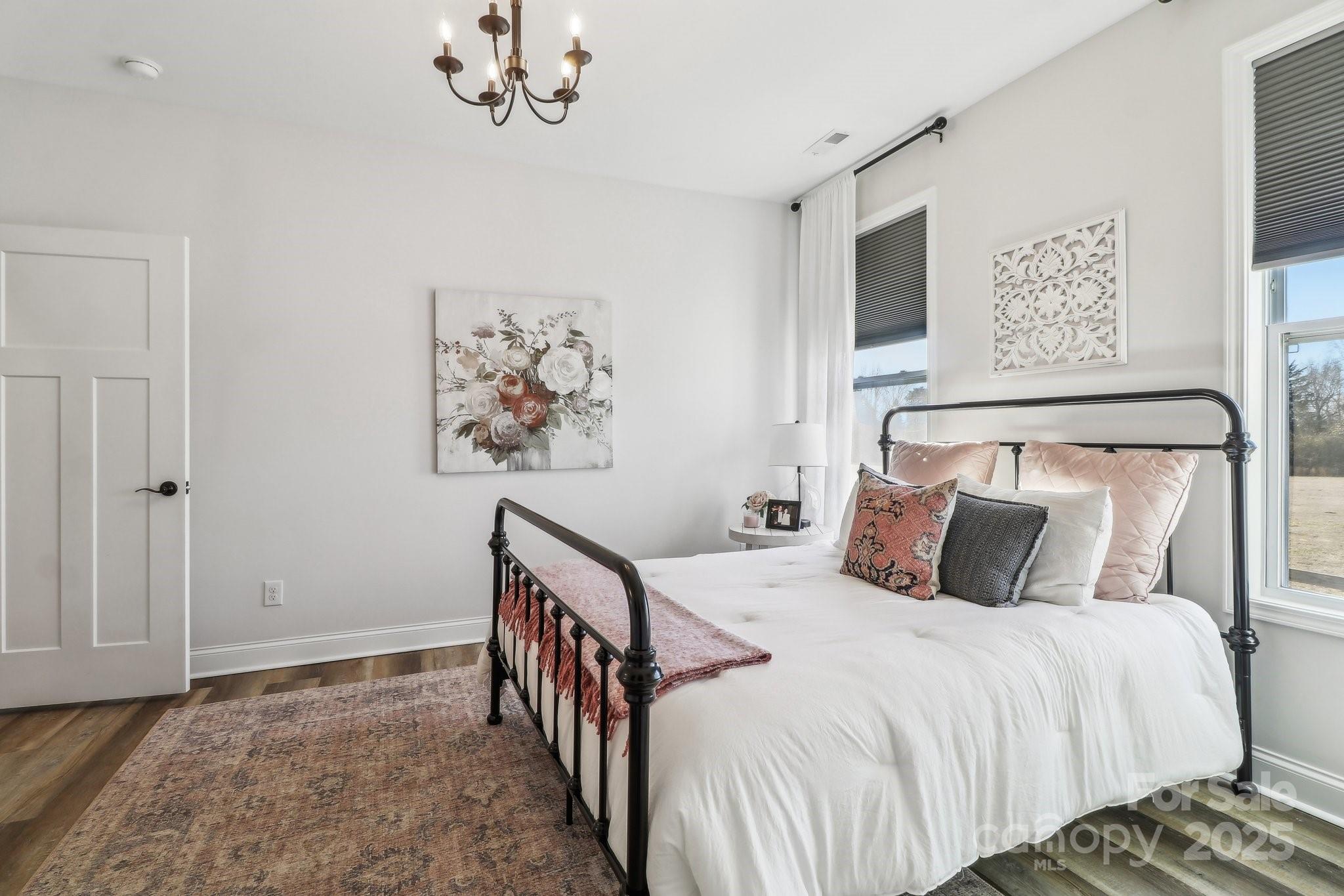 754 Culp Fergusen Drive Lancaster, SC 29720 - Photo 23 of 35 a bedroom with a bed and a chandelier