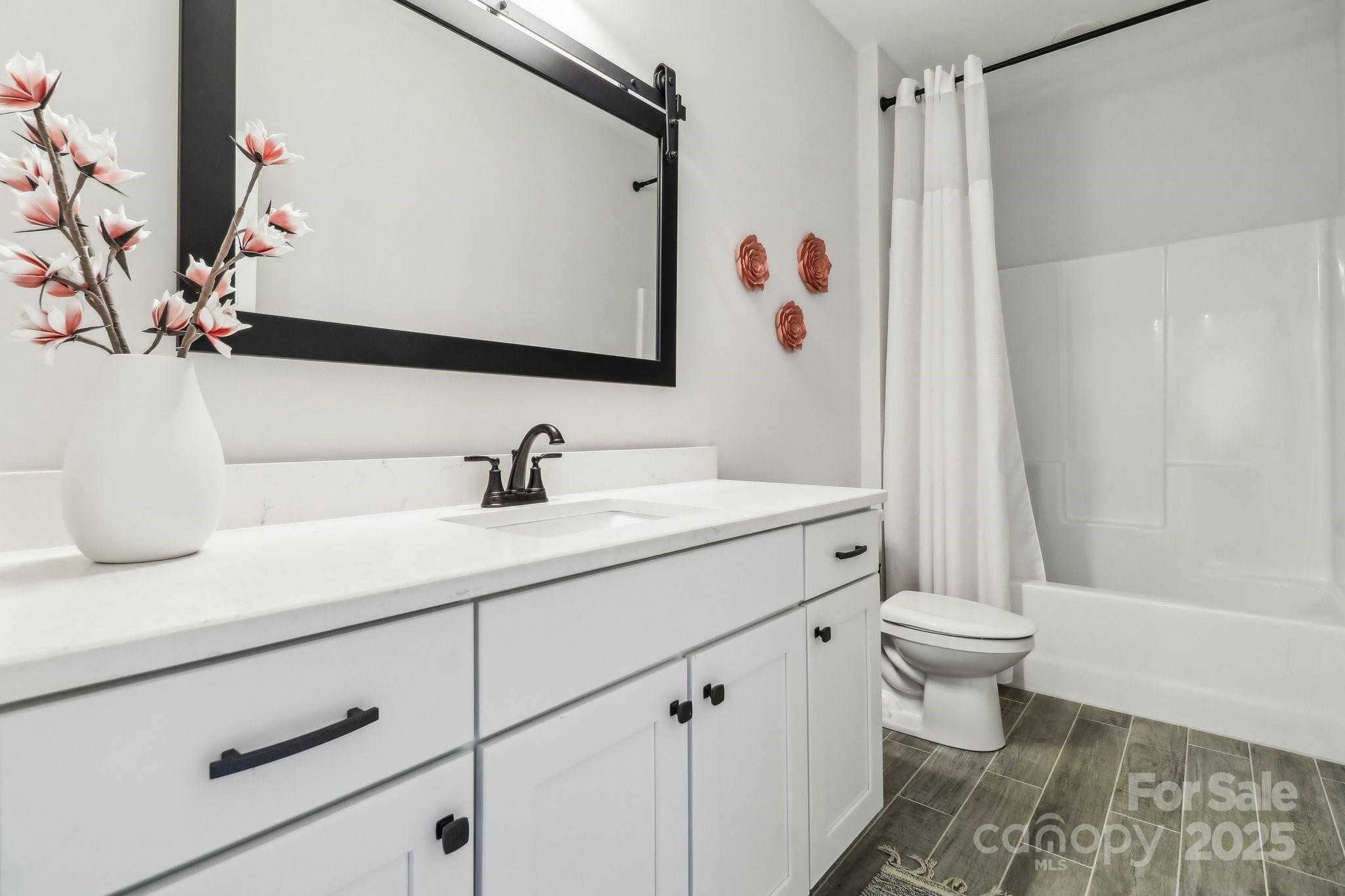 754 Culp Fergusen Drive Lancaster, SC 29720 - Photo 24 of 35 a bathroom with a sink a toilet and a large mirror