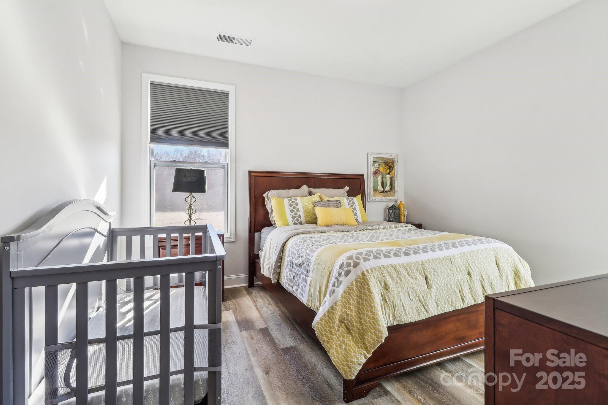 754 Culp Fergusen Drive Lancaster, SC 29720 - Photo 27 of 35 a bedroom with a bed and wooden floor
