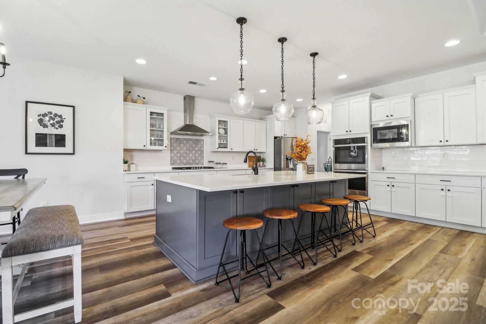 754 Culp Fergusen Drive Lancaster, SC 29720 - Photo 4 of 35 a large kitchen with stainless steel appliances kitchen island granite countertop a sink and cabinets