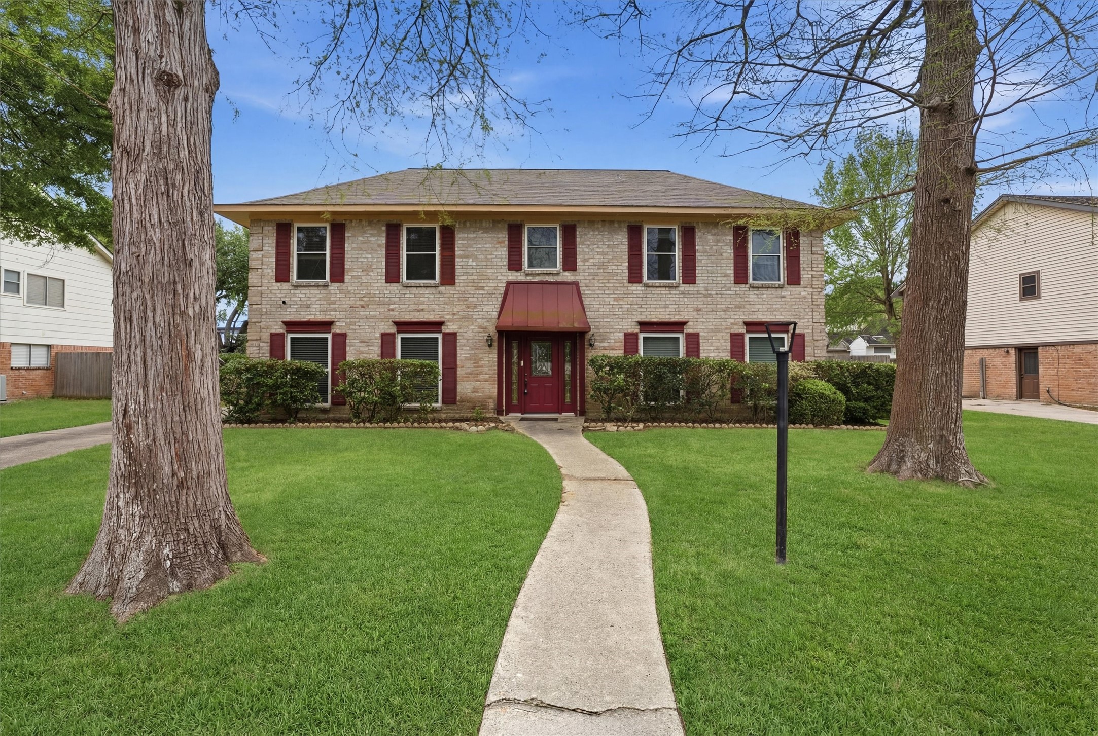 8115 Theisswood Road Spring, TX 77379 - Photo 1 of 41 Welcome to this classic two-story brick and wood home, beautifully situated on a lush lot with mature trees in the highly sought-after Memorial Northwest community.