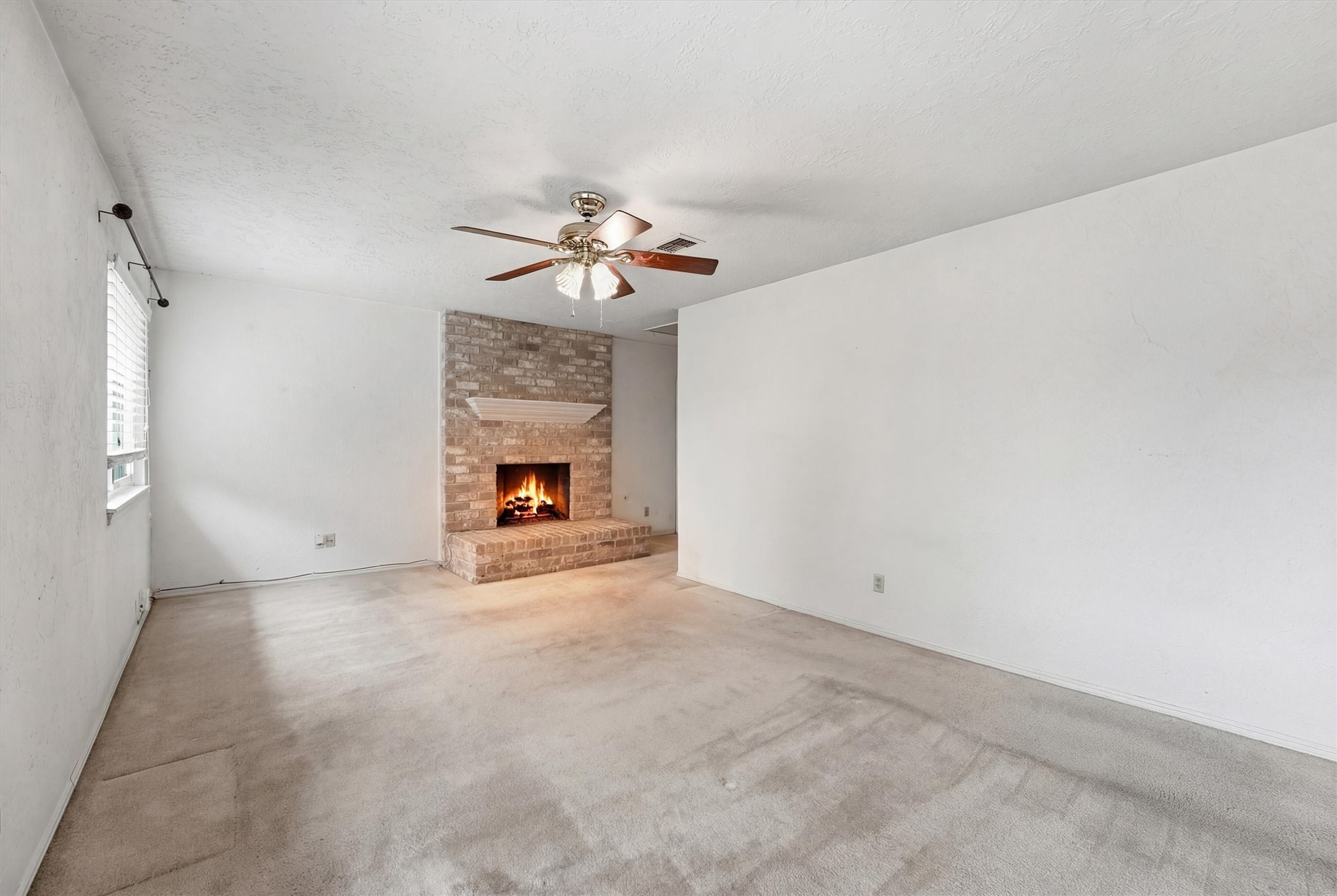 8115 Theisswood Road Spring, TX 77379 - Photo 26 of 41 primary bedroom view highlighting the rare feature of a corner brick fireplace.