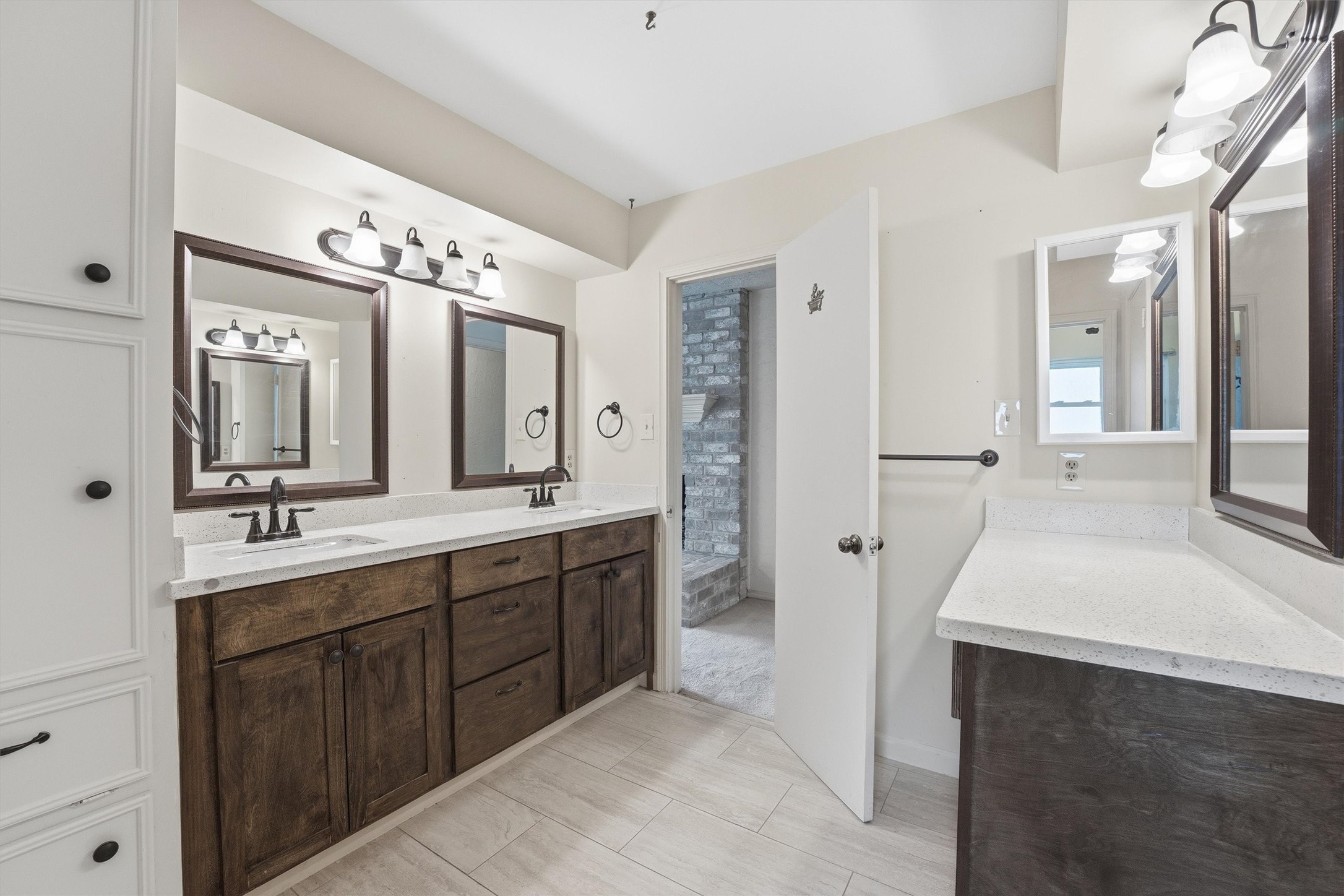 8115 Theisswood Road Spring, TX 77379 - Photo 27 of 41 updated primary bathroom with quartz dual vanity and subway tile walk-in shower.
