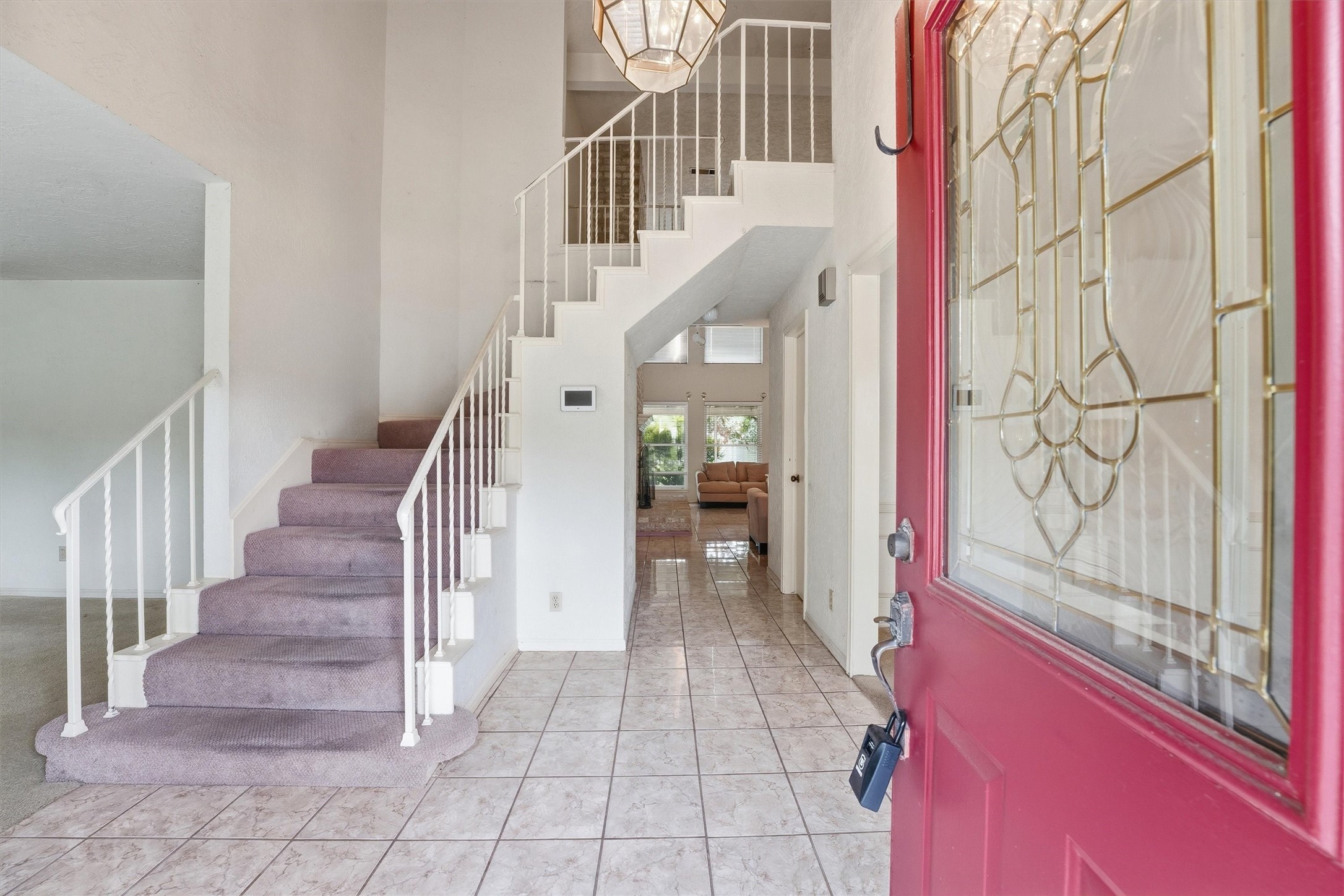8115 Theisswood Road Spring, TX 77379 - Photo 4 of 41 inviting foyer, featuring a lovely decorative glass front door, easy-to-maintain tile flooring, and a sweeping staircase