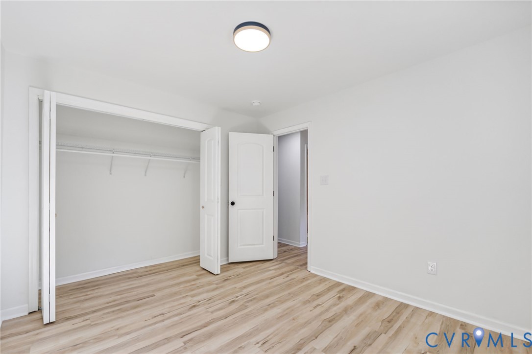 21514 Pannill Street Petersburg, VA 23803 - Photo 13 of 21 a view of an empty room with wooden floor and a window