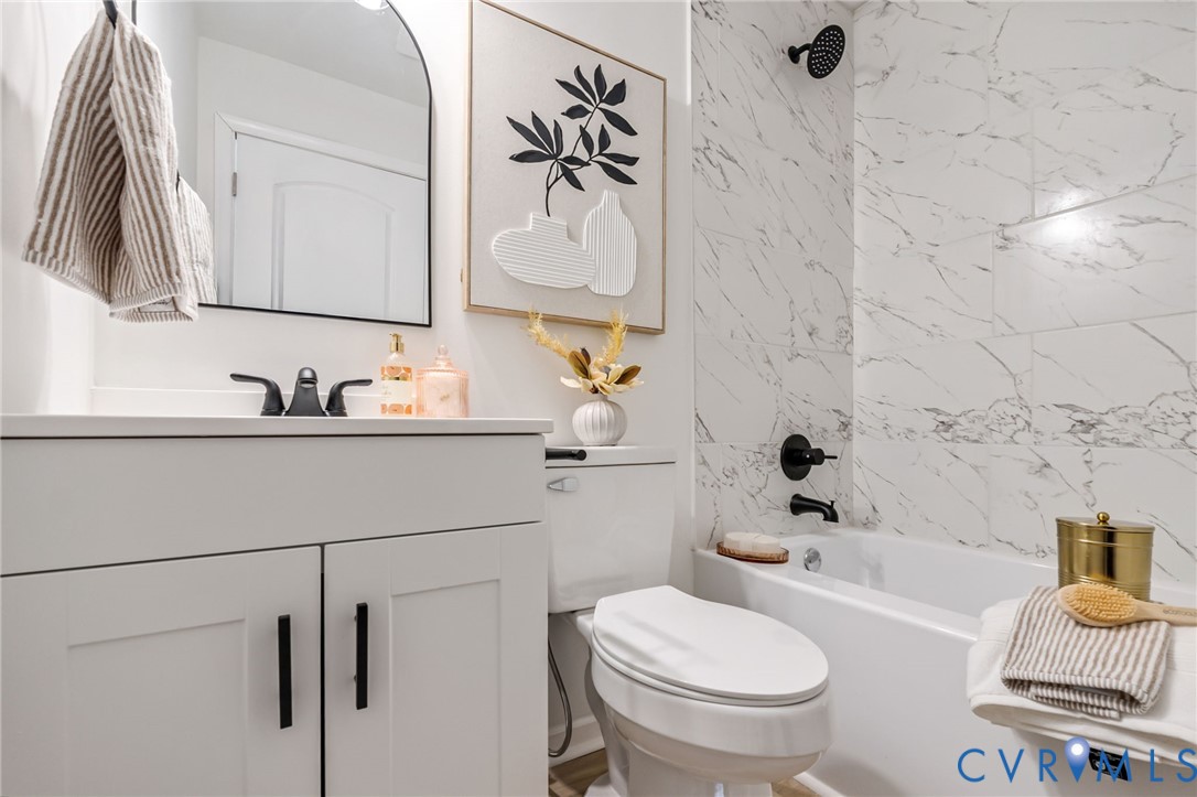 21514 Pannill Street Petersburg, VA 23803 - Photo 14 of 21 a bathroom with a sink a toilet and a bathtub