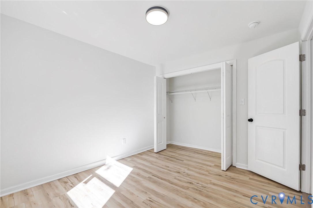 21514 Pannill Street Petersburg, VA 23803 - Photo 15 of 21 an empty room with wooden floor and windows