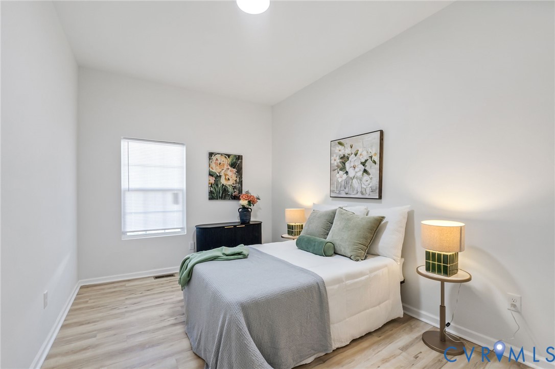 21514 Pannill Street Petersburg, VA 23803 - Photo 7 of 21 a bedroom with a bed and wooden floor