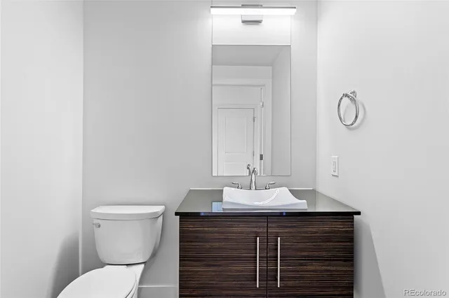 a bathroom with a sink vanity and toilet